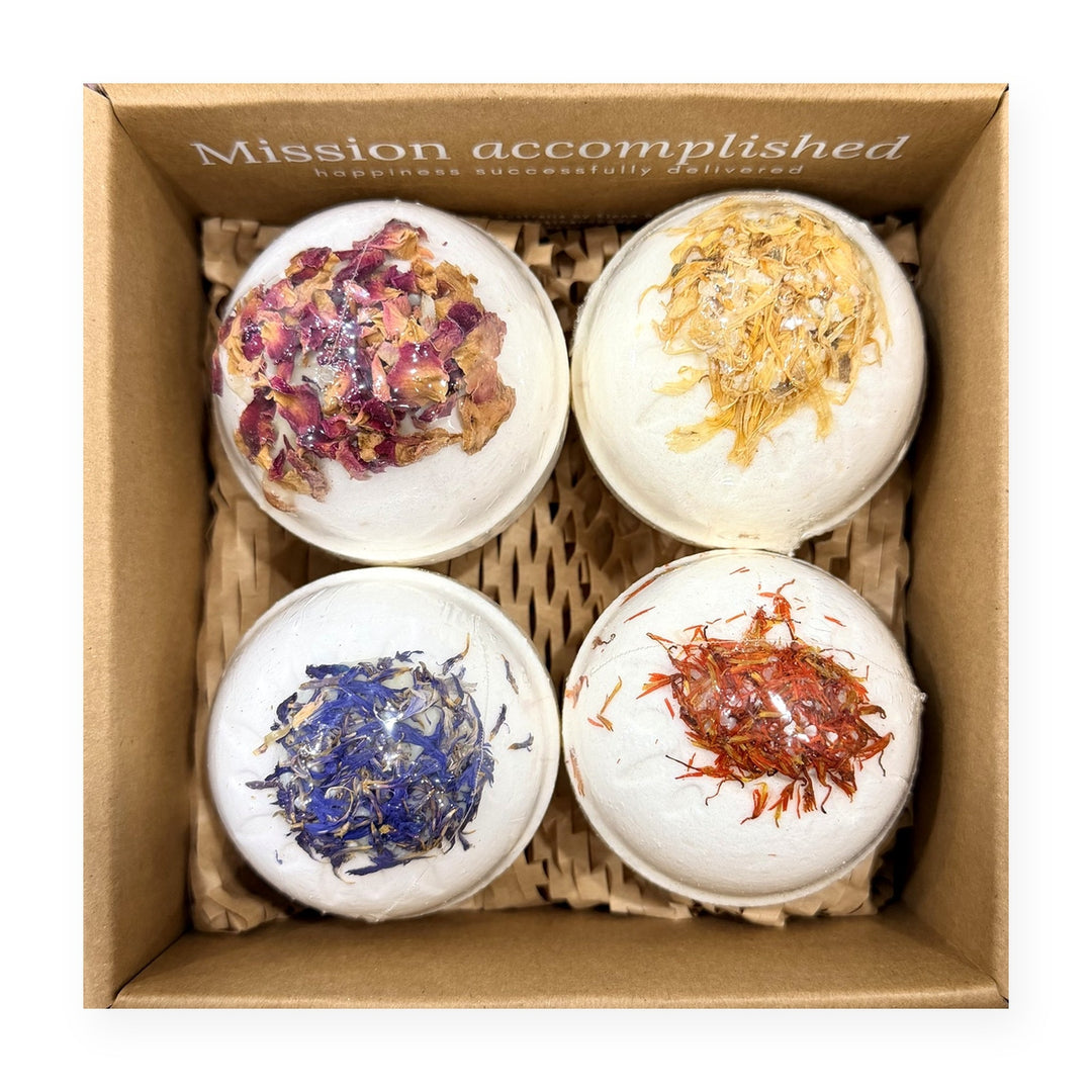 Botanical Bath Bomb Gift Box open, showing four handmade bath bombs topped with dried petals: Lavender, Tea Rose, Butter Bear and Cleopatra