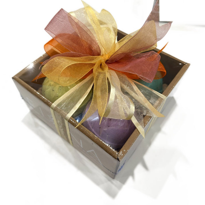 Hand wrapped aromatherapy bath bomb gift box in an ELENA kraft box with gold, pink and orange organza ribbon