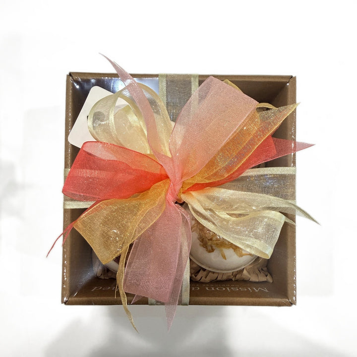 Top view of the wrapped Botanical Bath Bomb Gift Box with a peach, pink and gold ribbon bow