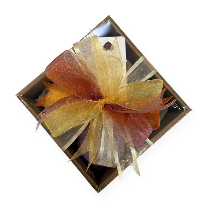 Aromatherapy bath bomb gift box with gold and pink ribbon and a gift card