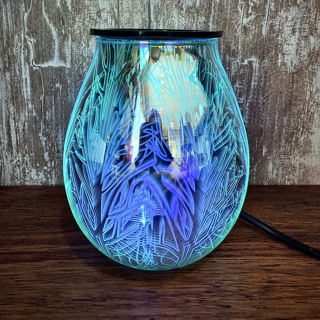 Twilight glass wax warmer glowing teal blue, fairy forest pattern lit up