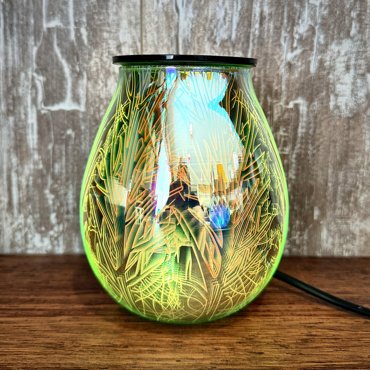 Twilight glass wax warmer glowing green and gold